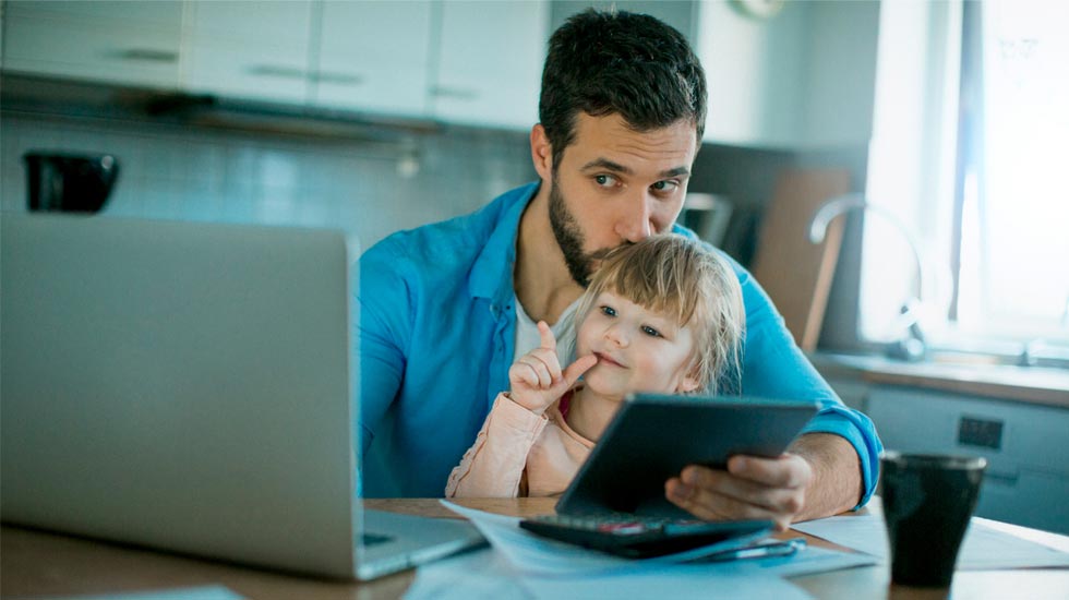 Father and doughter using laptop